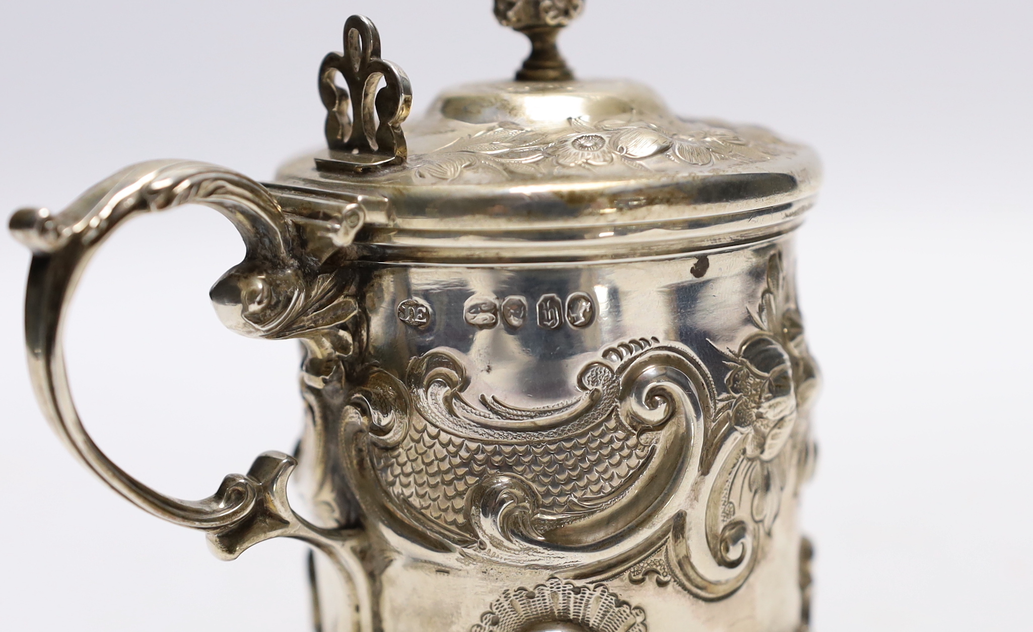 A Victorian embossed silver drum mustard, John Evans II, London, 1863, decorated with foliage and scrolls.